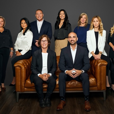 The Jeffery Group team around a leather sofa, from jefferygroupre.ca