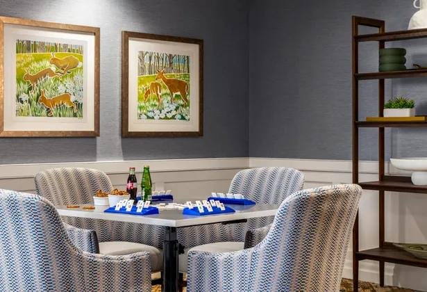 A games table set for a board game in an Amica Taunton shared lounge