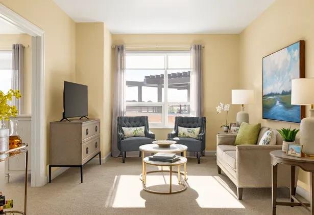 A bright sitting area at Amica Taunton with armchairs and large windows