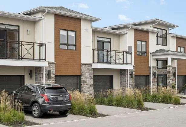 Two-storey townhomes at Amica Taunton with garages, balconies and landscaped front gardens